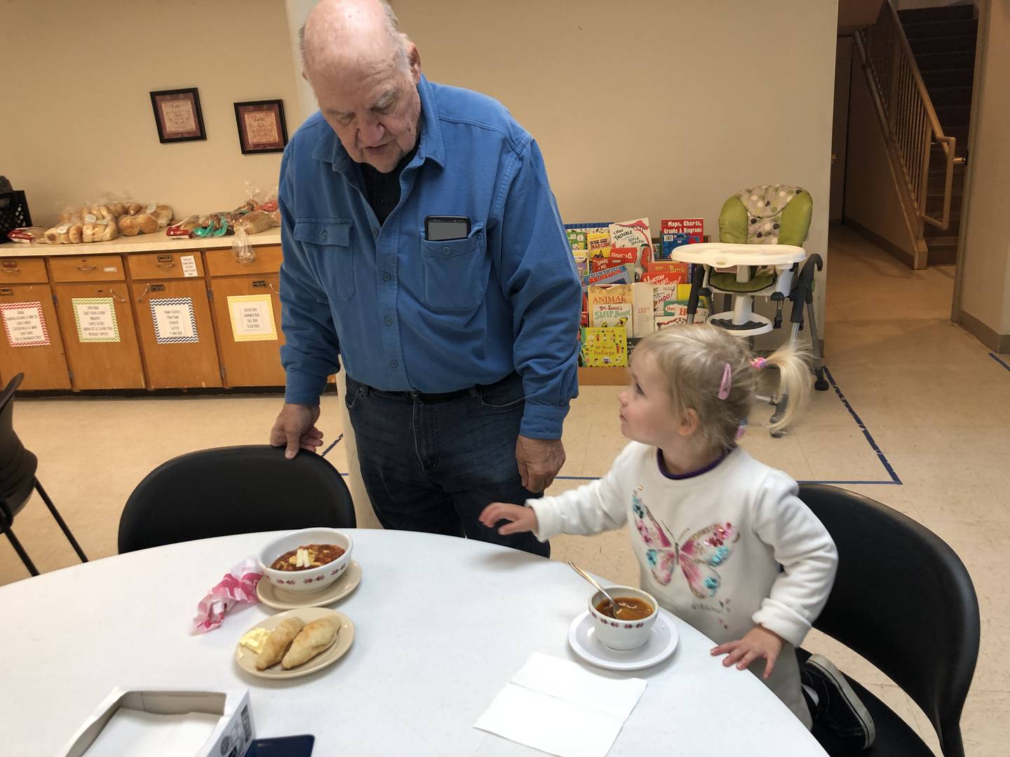 Dennis Demes and his granddaughter, Harmony Jenkins, were among the 50-plus people who shared a meal with neighbors at Marengo's Stone Soup Social on Oct. 18, 2022.