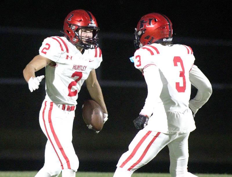 Huntley’s Zack Garifo, left, is greeted by Omare Segarra after a Garifo touchdown against Prairie Ridge in varsity football at Crystal Lake Friday night.