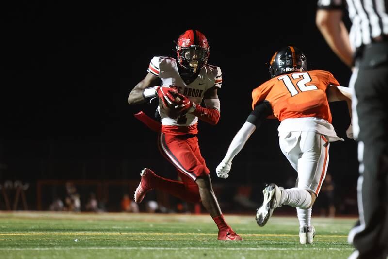 Bolingbrook’s Kyan Berry-Johnson takes a pass upfield against Lincoln-Way West on Friday, Sept. 22 in New Lenox.