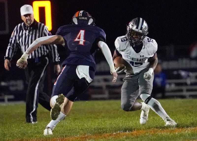 Oswego East's Jasiah Watson (13) carries the ball against Oswego during a football game at Oswego High School on Friday, Oct. 20, 2023.