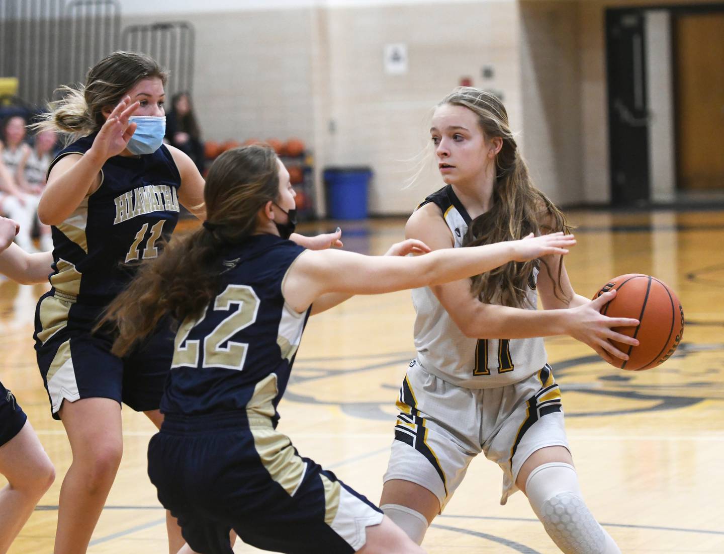 Polo's Courtney Grobe pulls the ball away from Hiawatha defenders Olivia Rotstein (22) and Crystal Haack (11) during 1A regional action in Polo on Saturday.