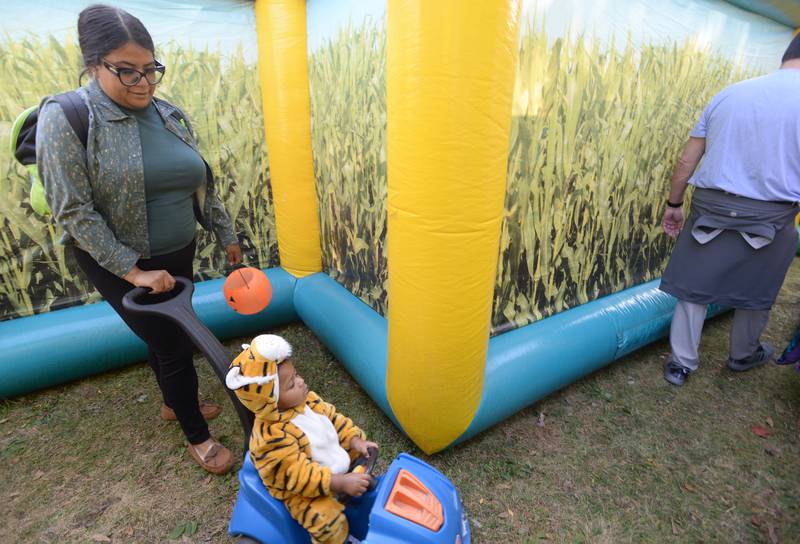 Families including Jailene Medel and Jaylon Dubose of Elmhurst walk through the inflatable corn maze during the Elmhurst Park District Family Fall Fest Saturday, Oct. 5, 2024.