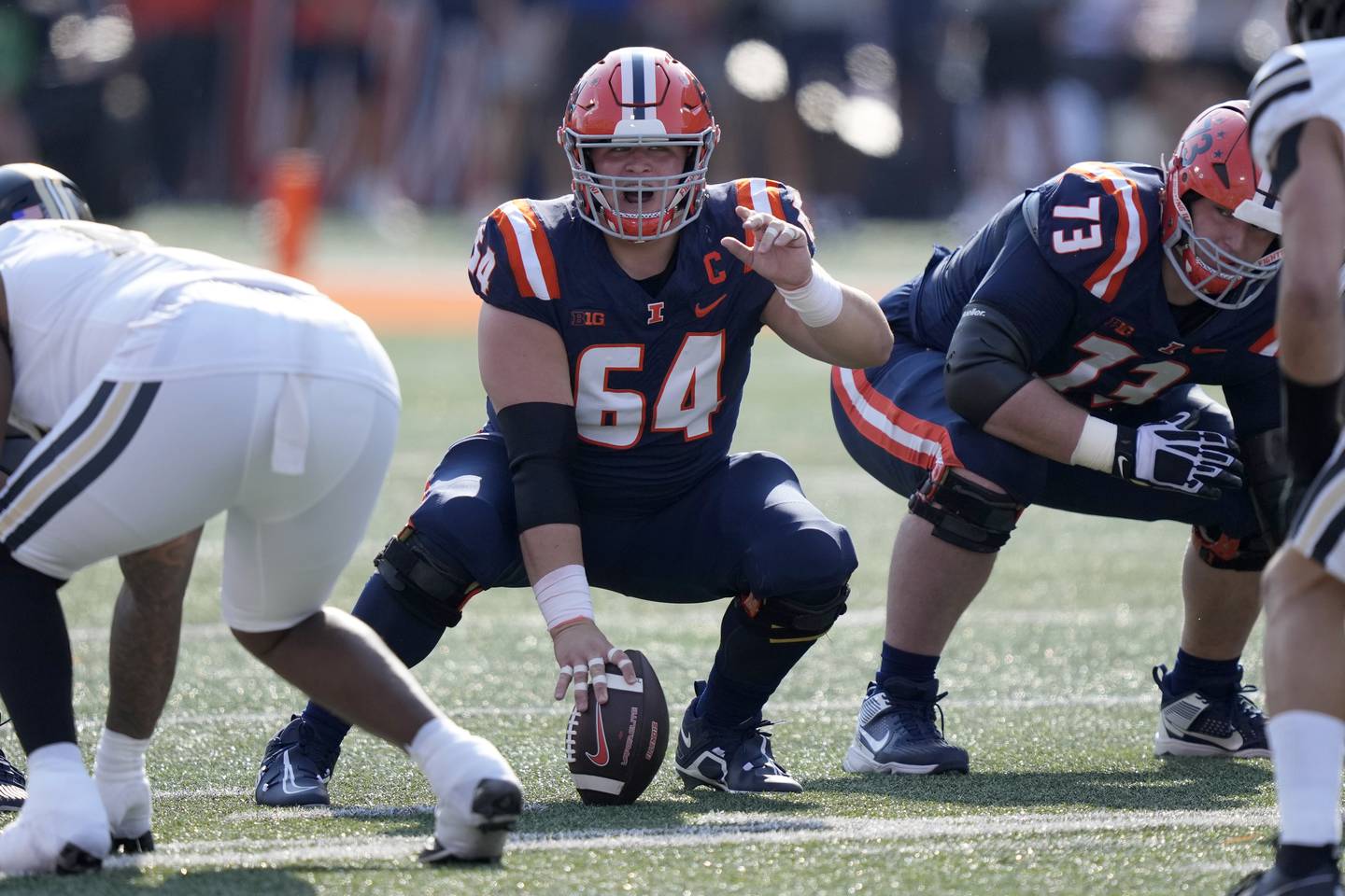 Illinois center Josh Kreutz calls out a blocking scheme during an NCAA college football game against Purdue in Champaign, Ill. (AP Photo/Charles Rex Arbogast)