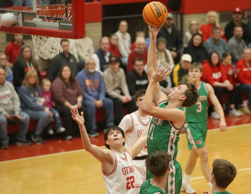 L-P's Jameson Hill lets go of a shot in the lane over Ottawa's Dominic Parks on Friday, Feb. 6, 2026 in Kingman Gymnasium at Ottawa High School.
