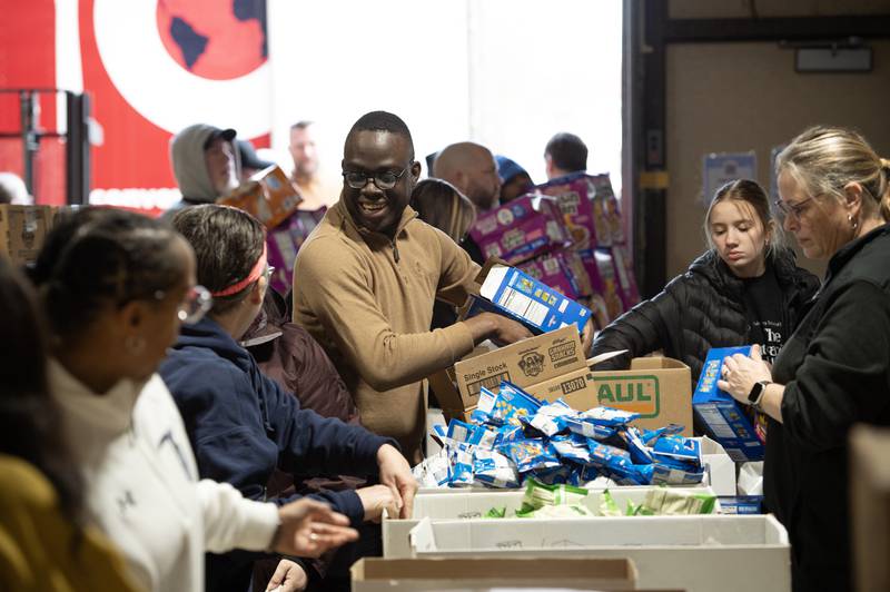 Ceejay Johnson, a teacher at King Middle School, sorts a box of donated food during a donation delivery by Convoy of Hope at Lincoln Cultural Center in Kankakee on Thursday, March 12, 2026.