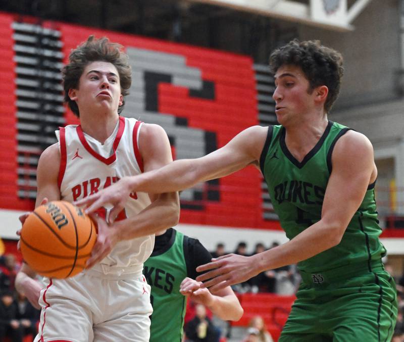 Palatine’s Carter Monroe, left, grabs a rebound in front of York’s James DeCiccio during the Palatine boys basketball tournament on Friday, Nov. 29, 2024 in Palatine.
