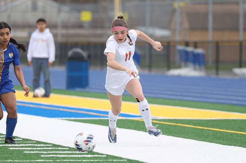 Plainfield East’s Caroline Dinnon works the ball along the sidelines against Joliet Central on Thursday, April 11, 2024.