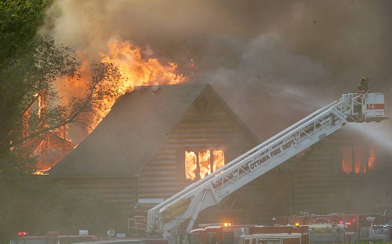 Ottawa firefighters use their aerial fire truck to extinguish flames at Grand Bear Resort on Monday, May 30, 2022.