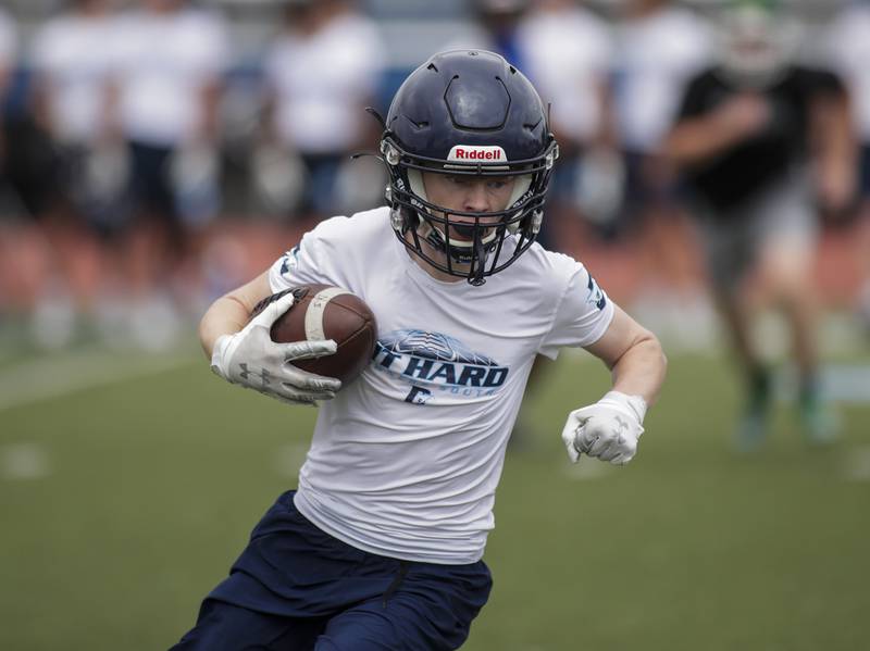 Downers Grove South’s Josh Weber picks up yards after a catch during the Downers Grove South 7-on-7 in Downers Grove on Saturday, July 16, 2022.