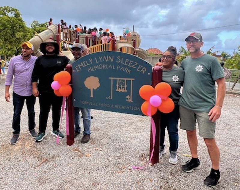 Scott Sleezer (far right) is joined with the mayor (second left) of Cabrera, Dominican Republic, and volunteers of the non-profit, Kids Around the World, to celebrate the grand opening of Emily Sleezer Park in the Dominican Republic, named after Sleezer's daughter. The park was originally located in Yorkville before being dismantled and refurbished by the charity.