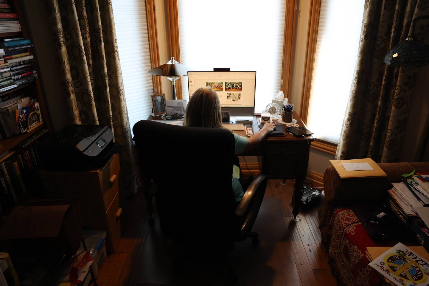 Marianne Wolf-Astrauskas, seen on Tuesday, Sept. 20, 2022, in Orland Park, spent several hours a day for six months to put together her 50th reunion book. The result was a 70-page book for the combined 50th reunion of the former Joliet Catholic High School and St. Francis Academy.