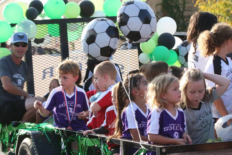 Kids ride the Midwest Youth Soccer League float during the Hall High School Homecoming parade on Thursday, Sept. 28, 2023 in Spring Valley.
