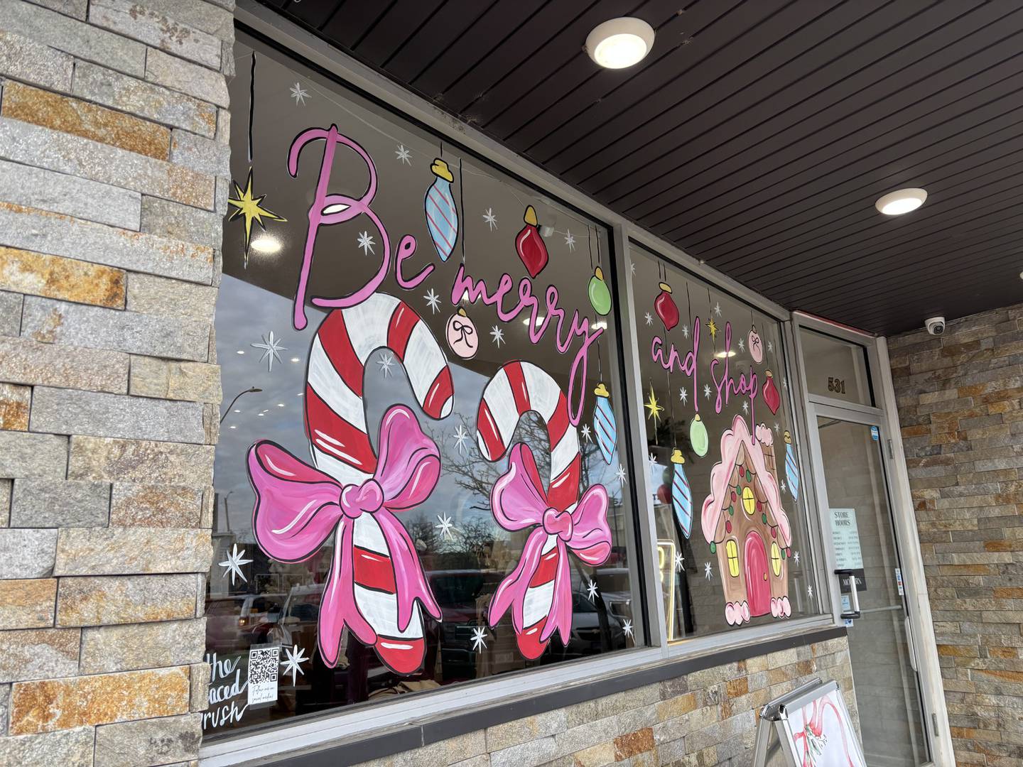 Lacey Haltenhof painted 22 business windows this holiday season, included this one at Modern Creek Boutique in downtown La Salle.