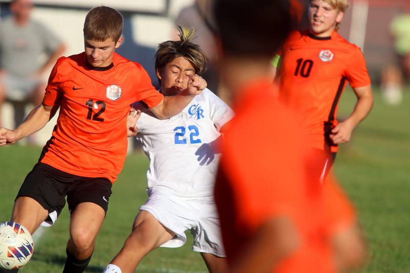 Burlington Central’s  AJ Valladares, center, battles Crystal Lake Central’s Justin Moore, left, in varsity soccer on Thursday Sept. 26, 2024, at Crystal Lake Central High School in Crystal Lake.