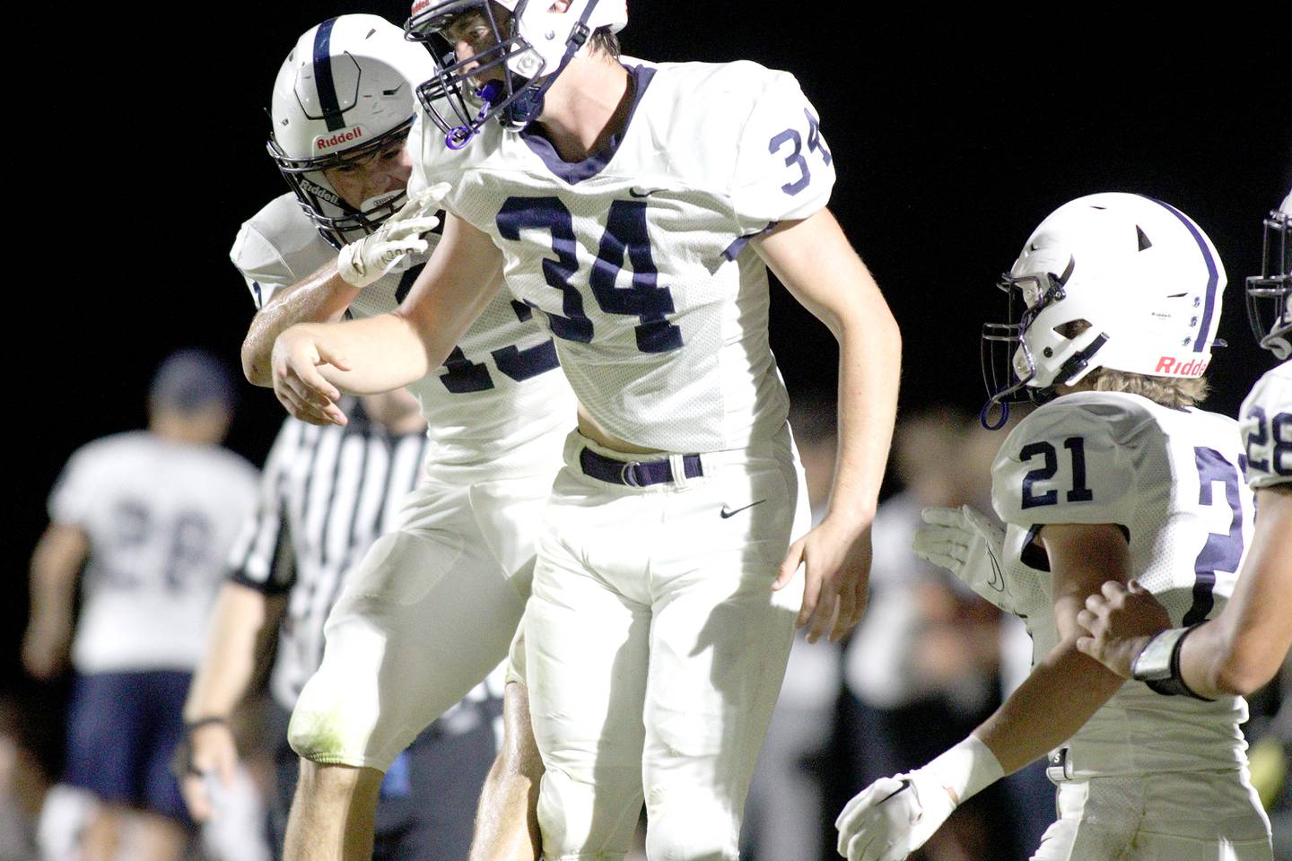 Cary-Grove’s Jack Rocen, front, and Corey Adams, back, celebrate a defensive stop in varsity football at Metcalf Field in Crystal Lake Friday night.
