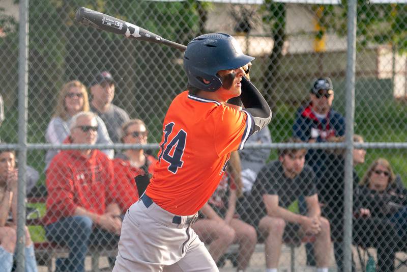 Oswego’s Trey Hernandez (14) singles driving in two runs against Yorkville during a baseball game at Yorkville High School on Monday, May 15, 2023.