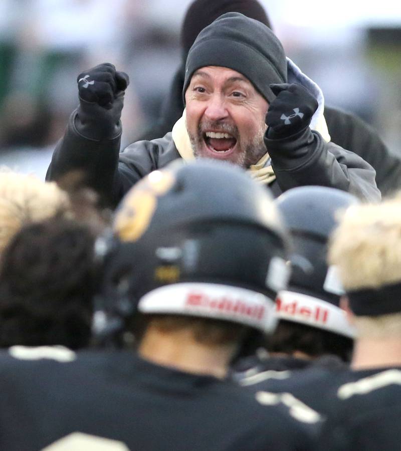 Sycamore head coach Joe Ryan celebrates with his team after the Spartans defeated St. Patrick 14-0 in their IHSA Class 5A state quarterfinal game Saturday, Nov. 13, 2021, at Sycamore High School.