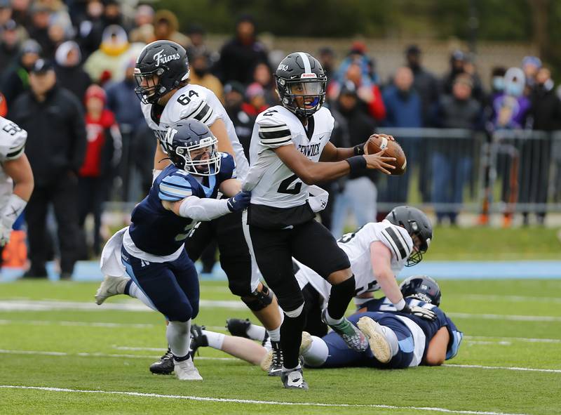 Fenwick's Kaden Cobb tries to escape from Nazareth's Nolan Morris during the IHSA Class 5A varsity football quarterfinal playoff game between Fenwick High School and Nazareth Academy on Saturday, November 13, 2021 in La Grange Park.