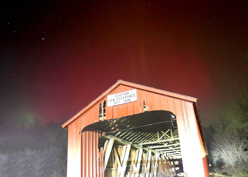 A view of theAurora Borealis (Northern Lights) over the Red Covered Bridge on Tuesday, Nov. 11, 2025. Two coronal mass ejections (CMEs) created sparking geomagnetic storm conditions, according to the National Oceanic and Atmospheric Administration (NOAA). Space weather forecasters anticipate that geomagnetic activity may intensify to strong (G3) conditions overnight and could be around again tomorrow night.