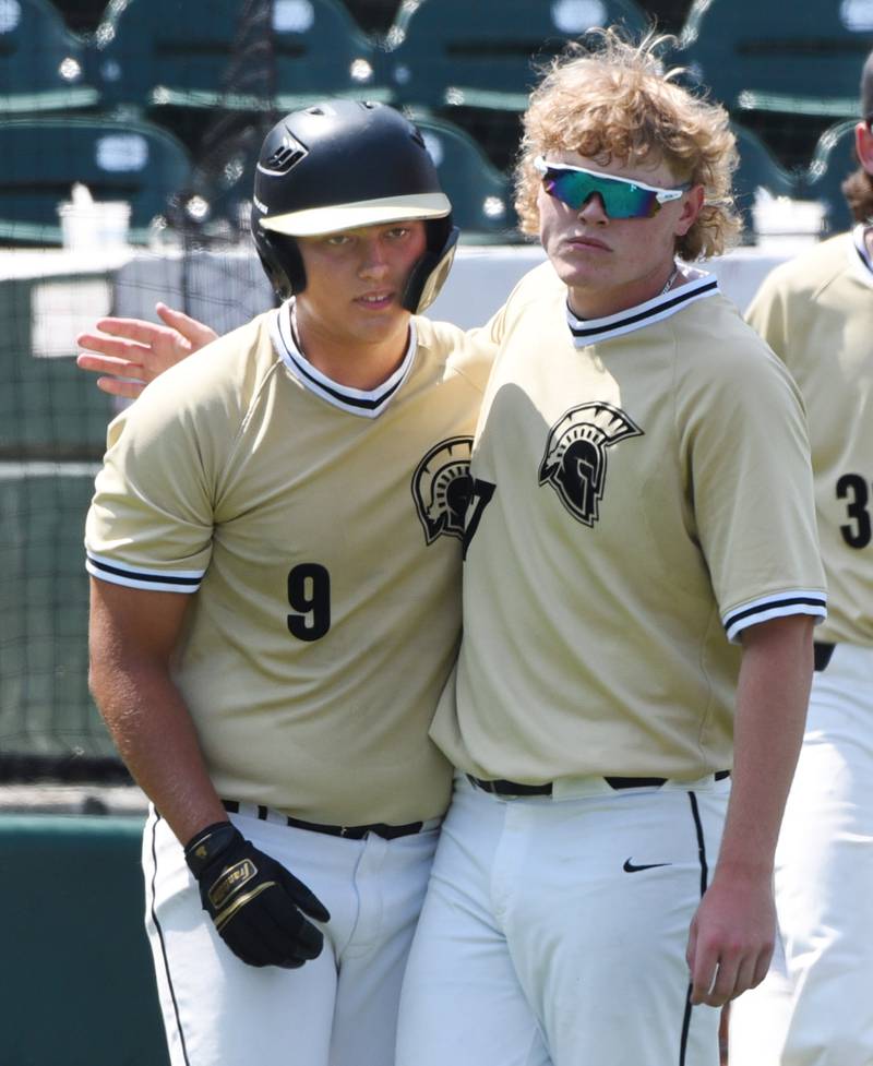 Joe Lewnard/jlewnard@dailyherald.com
Sycamore’s Jimmy Amptmann, right, puts his arm around teammate Matthew Rosado after the Spartans lost to Nazareth 3-0 during the Class 3A state baseball semifinal in Joliet Friday.