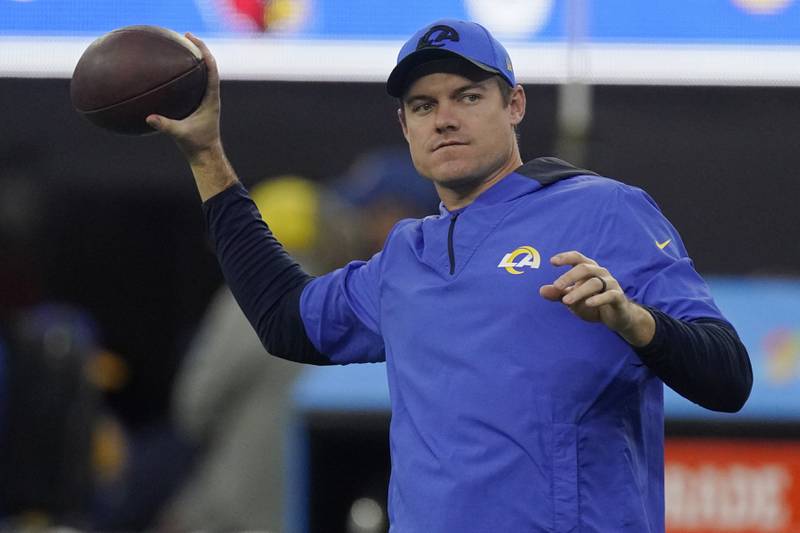 Los Angeles Rams offensive coordinator Kevin O'Connell tosses a football before the Rams faced the Arizona Cardinals in a Wildcard game Monday, Jan. 17, 2022.