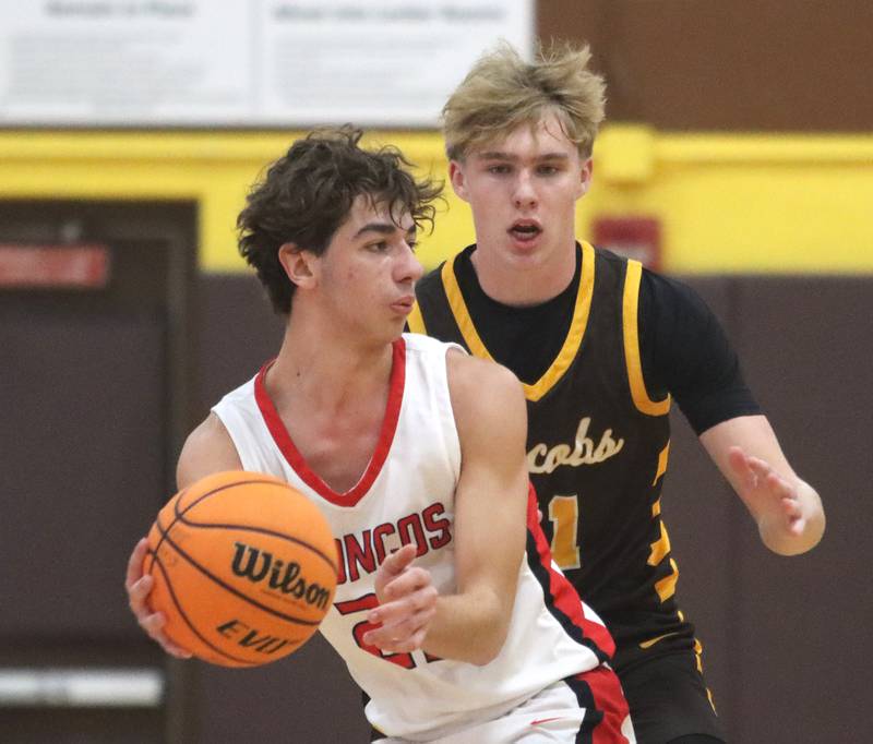 Jacobs’ Carson Goehring, back, guards Barrington’s Gus Edstrom during Hinkle Holiday Classic varsity boys basketball tournament action on Monday, Dec. 23, 2024 at Jacobs High School in Algonquin.