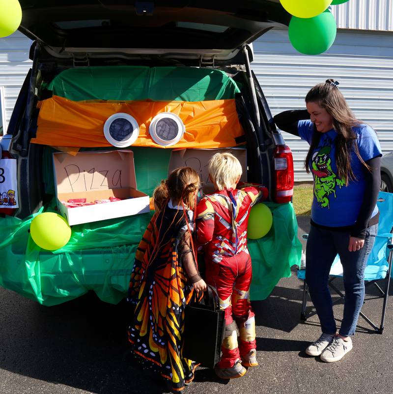 Roxy and Roscoe Fletcher get candy during the Trick or Trunk at the Fox Valley Family YMCA West branch Trick or Trunk on Sunday, Oct. 26, 2025 in Sandwich.