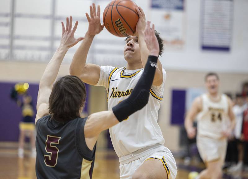 Sterling’s Andre Klaver goes to the hoop against Morris’ Caston Norris Wednesday, Feb. 22, 2023 in the 3A sectional semifinal game.