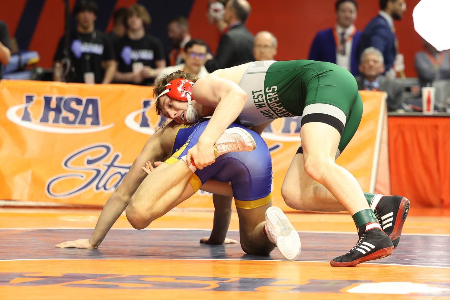 Glenbard West’s Collin Carrigan looks to drop Lyons’ Gunnar Garelli in the 165-pound Class 3A state championship match on Saturday, Feb. 17th, 2024 in Champaign.
