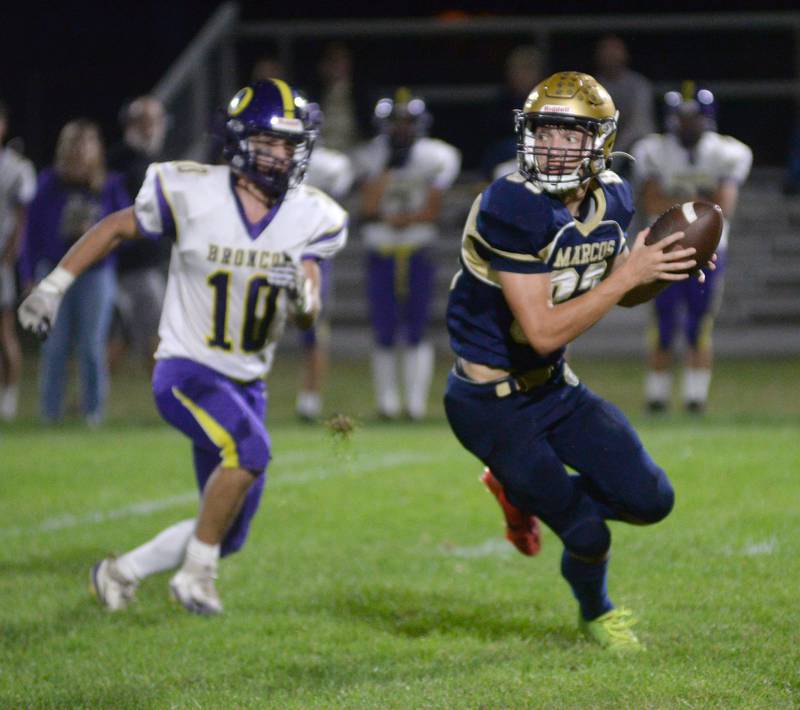 Polo's Mercer Mumford (83) looks upfield as Orangeville's Oskar Bissell reacts during 8-man action at Polo High School on Friday, Oct. 3, 2025.