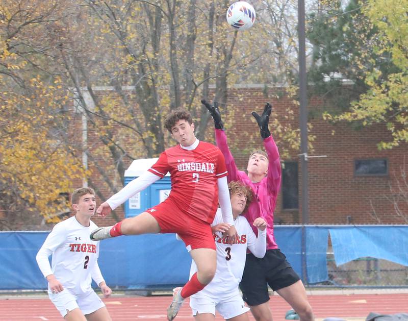 Hindsdale's Christopher Koulouris leaps in the air to go in for a header as Edwardsville players Lincoln Alwart, Gavil Lieberman and Collin Schlechte keep him away during the Class 3A State third place game on Saturday, Nov. 9, 2024 at Hoffman Estates High School.