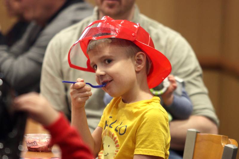 Connor McGuigan, 5, of Huntley, digs into his ice cream during a Read & Eat Fries With a Firefighter event Thursday, March 16, 2023, at the Culver’s in Huntley.
