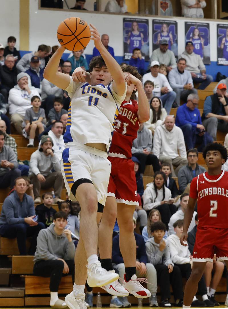 Lyons Township's Tommy Blyth (11) grabs a rebound during a varsity basketball game between Hinsdale Central and Lyons Township high schools on Friday, Dec. 12, 2025 in La Grange.