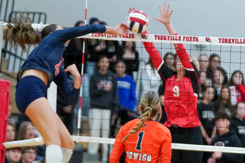 Yorkville's Lilianna Casbarian (9) blocks a kill attempt by Oswego’s Sidney Hamaker (13) during the Class 4A Yorkville Regional final at Yorkville High School on Thursday, Oct. 31, 2024.