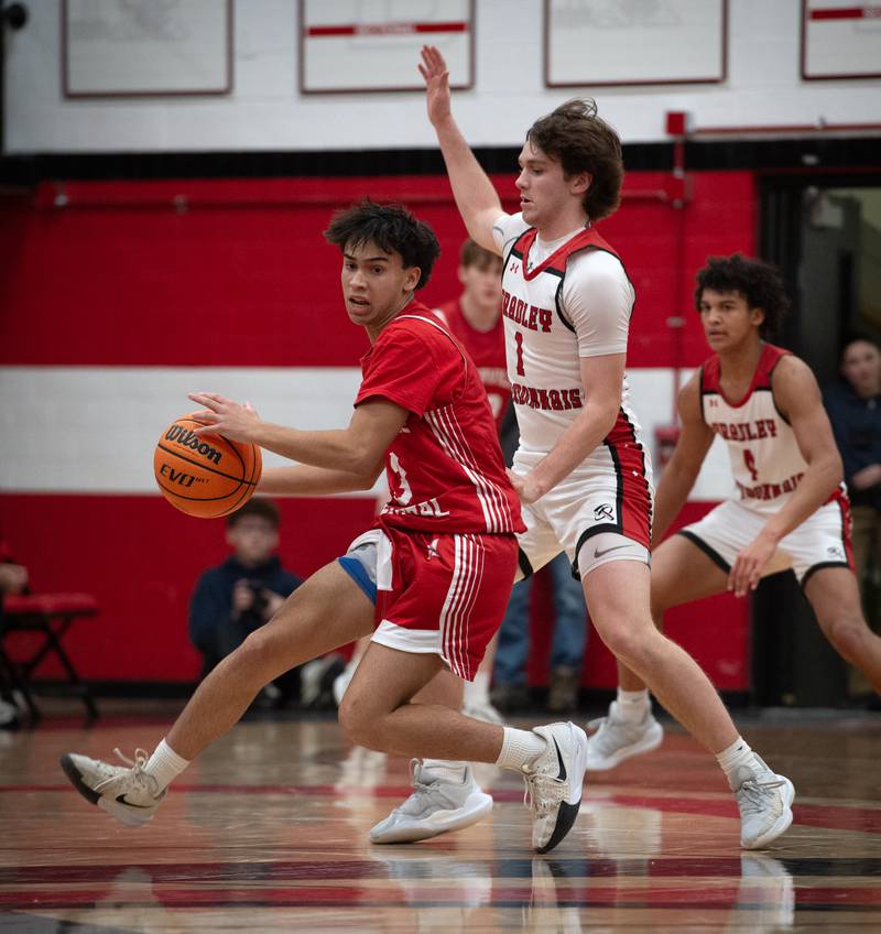 Naperville Central's Mason Jones, left, controls the ball as Bradley-Bourbonnais's Drew Kubal guards in a game on Monday, December 15, 2025.
