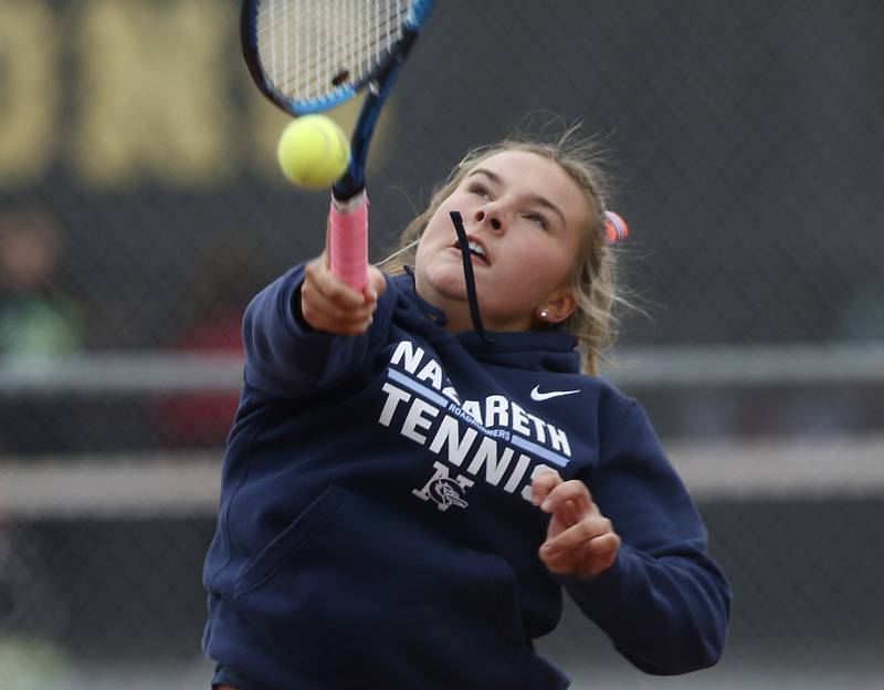 Nazareth Academy’s McCahey Hardy returns the ball Thursday, Oct. 20, 2022, during during the first day of the IHSA State Girls Tennis Tournament at Schaumburg High School in Schaumburg.