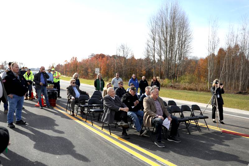 A small crowd gathered in the middle of Bliss Road for the ribbon cutting for the $12 million realignment of Bliss Road and a new roundabout connecting Bliss Road, Main Street Road and Fabyan Parkway in Blackberry Township on Thursday, Nov. 16, 2023.