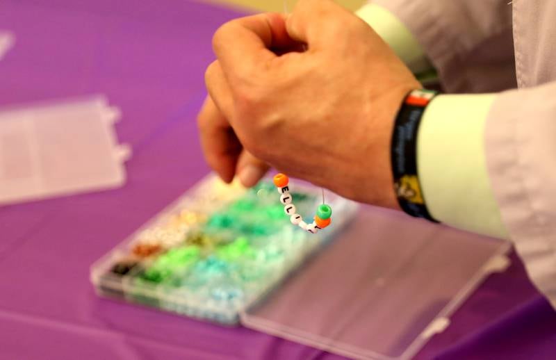 Luis Saltigerald, assistant chaplain at Northwestern Medicine Central DuPage Hospital in Winfield, makes a friendship bracelet as part of the hospital’s National Nurses Week activities on Monday, May 6, 2024.