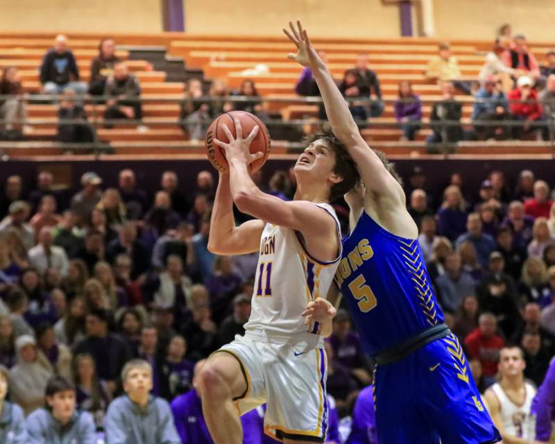 Downers Grove North's Owen Thulin (11) puts up a contested shot during varsity basketball game between Lyons at Downers Grove North.  Jan 31, 2023.