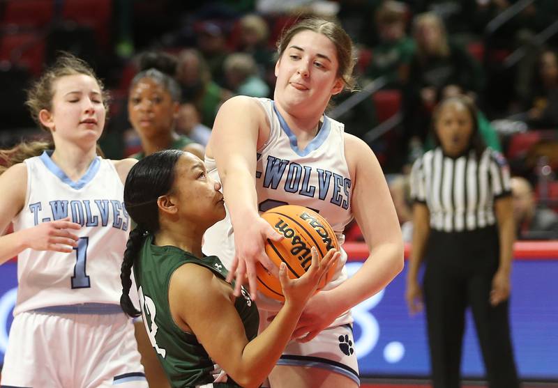 Cissna Park's Lauryn Hamrick knocks the ball free from St. Edward's Madeline Sasis while driving in the lane during the Class 1A third place game on Friday, March 7, 2025 at CEFCU Arena in Normal.