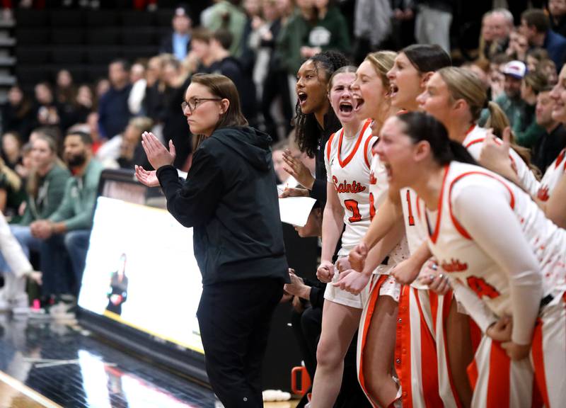 St. Charles East's head coach Katie Claussner cheers on her team during a Class 4A St. Charles East Sectional semifinal against Glenbard West on Tuesday, Feb. 25, 2025 in St. Charles.