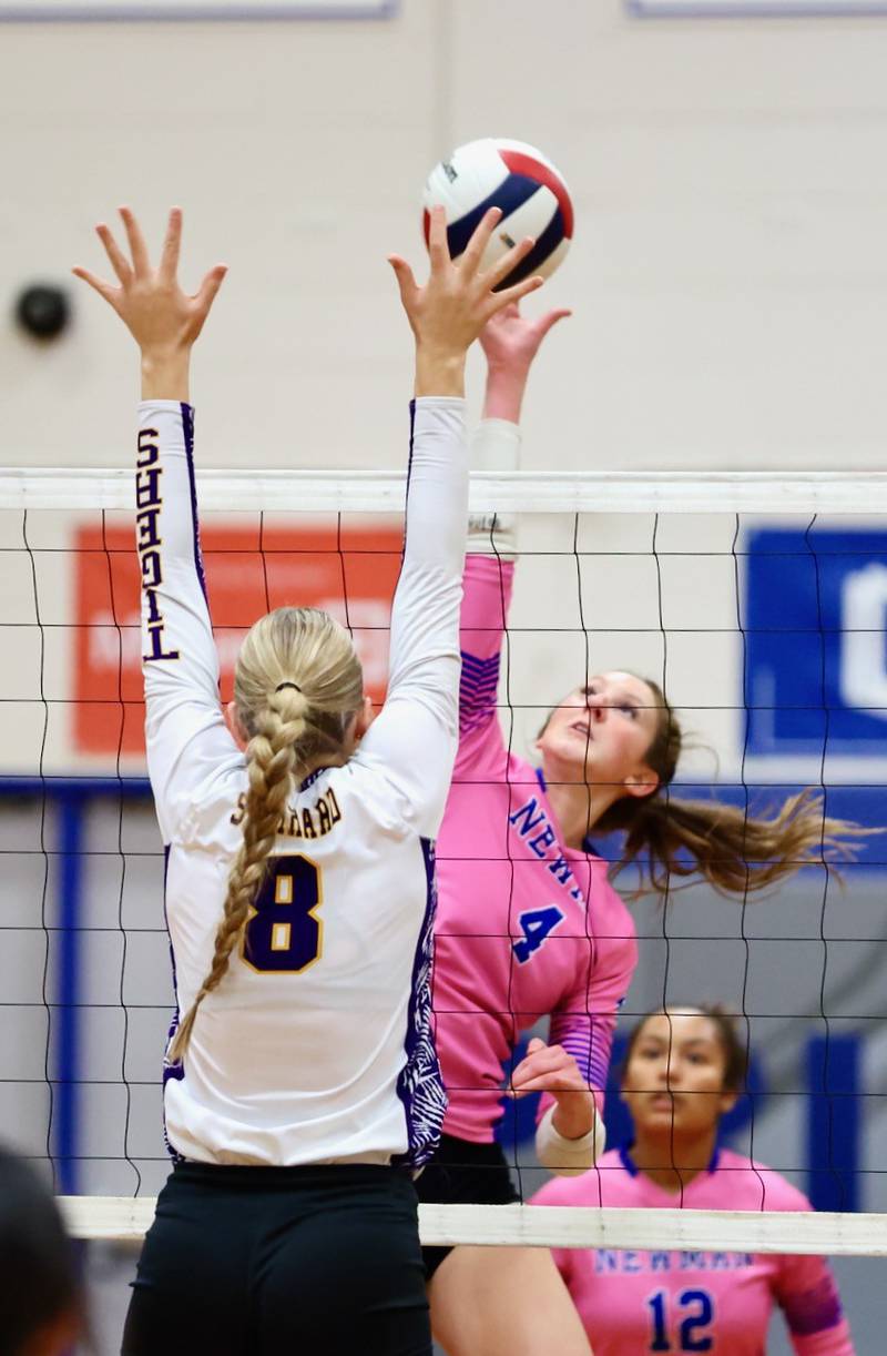 Newman sophomore Ruby Burger hits over Sherrard's Grace Bohnert in Tuesday's regional semifinal match at Princeton.