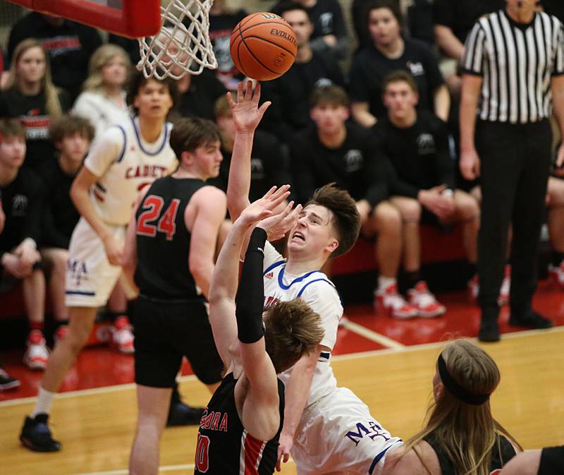 Marmion's Collin Wainscott runs in the lane to get a shot off over Metamora's Tyler Mason during the Class 3A Super-Sectional on Monday, March 6, 2023 at Ottawa High School.