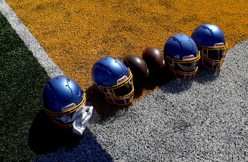Footballs and helmets on the turf at the Northern Burbs Football Showcase on Monday, May 4, 2026, at Johnsburg High School. Over 165 players from 15 teams demonstrated their football skills to over 60 college coaches.