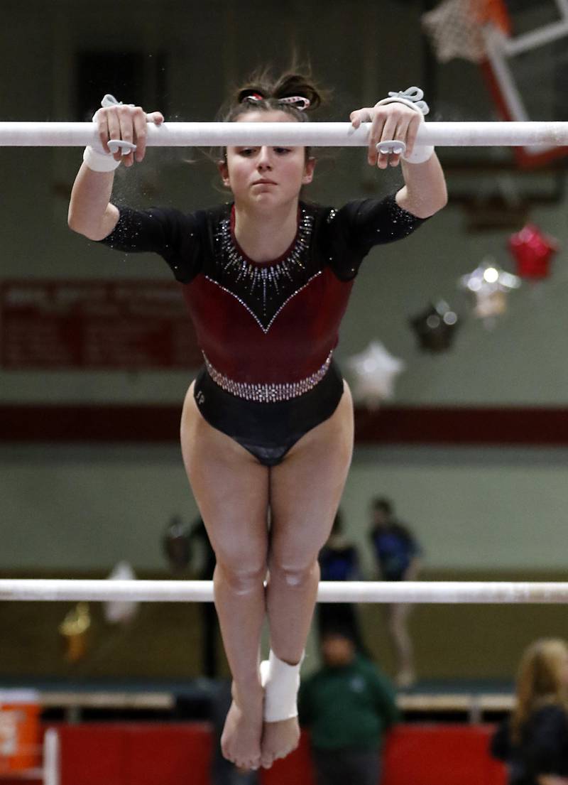 Prairie Ridge’s Tess Morton competes on the uneven parallel bars  during the IHSA Mundelein Gymnastics Sectional on Feb. 13, 2025, at Mundelein High School.