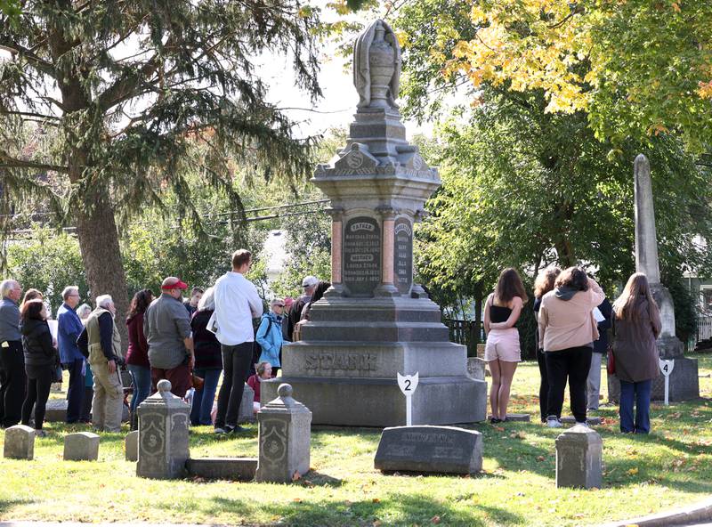 Visitors walk the grounds of Elmwood Cemetery in Sycamore Sunday, Oct. 9, 2022, during the Etched in Stone cemetery walk. The event, hosted by the DeKalb County History Center, told the stories of some local individuals who are buried there.