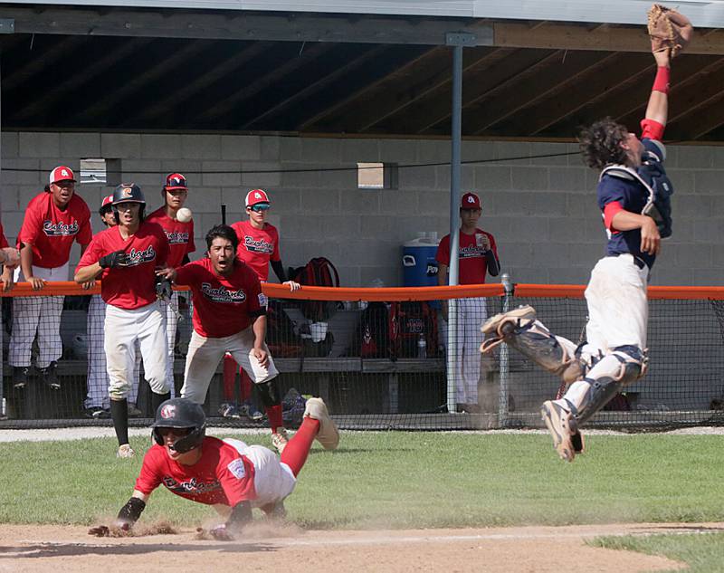 Burbank American's Blake Stefanek slides into home to score the game-tying run as Michigan catcher Ben Billo leaps for the throw during the Senior League Central Region championship Wednesday, July 27, 2022, at Schweickert Stadium at Veterans Park in Peru.