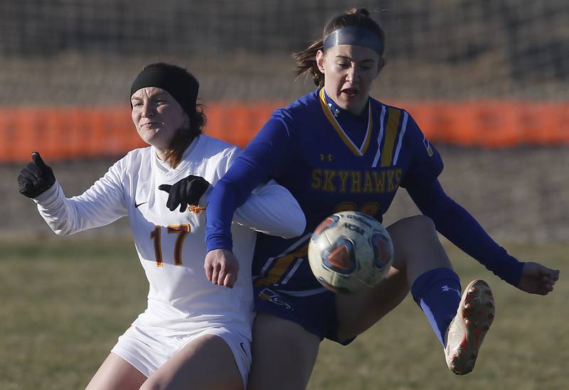 Johnsburg’s Elaina Moss tries to control the ball in front of Richmond-Burton’s Ella Pipe during a Kishwaukee River Conference soccer game on Wednesday, March 20, 2024, at Johnsburg High School.
