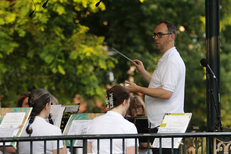 Bill Kraemer - Simpson conducts the Woodstock City Band as they perform on Wednesday, July 24, 2024, in the historic Woodstock Square. The band that is in its 140th season, performed their Galloping through the Gallery concert for the crowd.