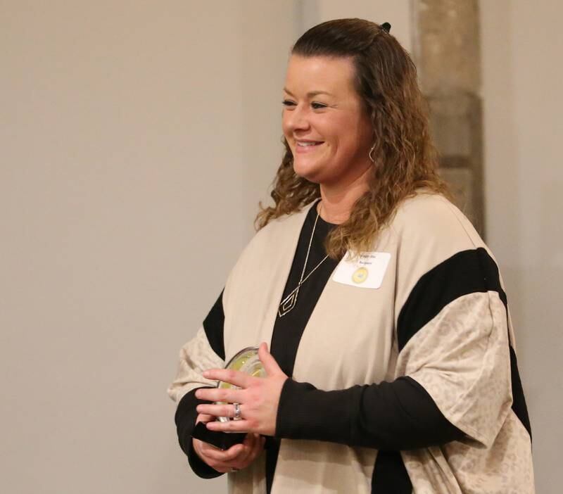 Megan Diss, Asst. Vice President and Loan Operations Supervisor, Eureka Savings Bank accepts her award during the Illinois Valley Chamber of Commerce 40 Under Forty Awards Gala on Thursday, Feb. 9, 2023 at Westclox in Peru.